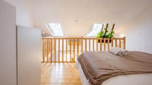 a bedroom with a bed in a room with windows at La Maisonnette - Hypercentre - Movie Theater in Dijon