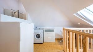 a laundry room with a washing machine and a staircase at La Maisonnette - Hypercentre - Movie Theater in Dijon