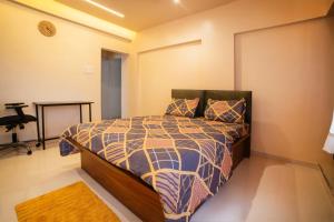 a bedroom with a bed in a room at Cosy Stay, balcony,Ambient Light in Kolhapur