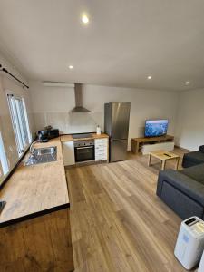 a large kitchen and living room with a couch and a kitchen and a kitchen at Confort House in Argentona