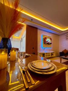 a dining room with a table with plates on it at Sunset Vibes Larache in Larache