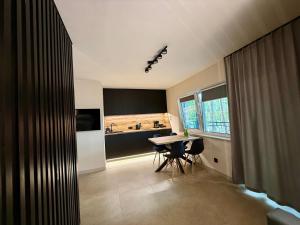 a kitchen with a table and chairs in a room at Turawa Lake Residence in Turawa