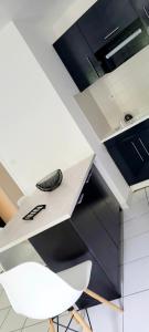 a white desk with a keyboard sitting on top of it at Appartement calme avec balcon in Pouzauges