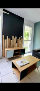 a living room with a table and a black wall at Appartement calme avec balcon in Pouzauges