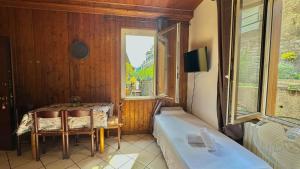 a dining room with a table and a window at The Courtyard Retreat in Brunate