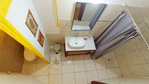 a small bathroom with a sink and a mirror at Native Heart Amazon Lodge in Shapaja +60 photos