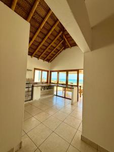 a large kitchen with a view of the ocean at Casa Waltako in Canoas +10 photos