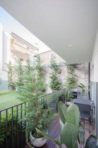 a balcony with trees and a table and chairs at Liiiving in Gaia - Cooper Residence Apartment II in Vila Nova de Gaia