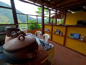 a dining room with a table and a view of a mountain at Native Heart Amazon Lodge in Shapaja
