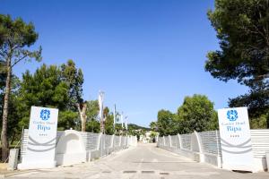 a bridge over a road with signs on it at Garden Hotel Ripa in Vieste