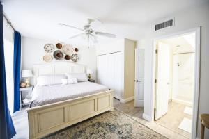 a bedroom with a bed and a ceiling fan at The Hamptons Hideaway in Hollywood
