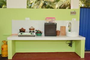 a kitchen counter with a microwave and a sink at Marino Bay Resort Kalametiya in Hambantota +14 photos