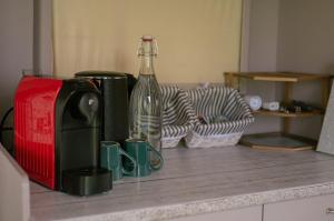 a wine bottle sitting next to a toaster on a counter at Dani's Wohnwagen B&B in Ramsen