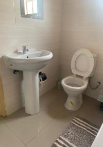 a bathroom with a sink and a toilet at MB guesthouse in Kasane