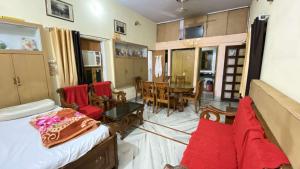 a living room with a couch and a dining room at Kusum Palace in Varanasi +23 photos