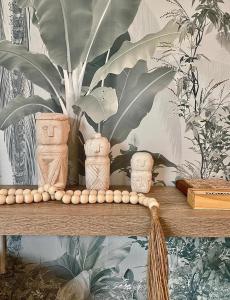 a shelf with a bunch of vases and a plant at Coastal Bliss Lodge with Direct Beach Access in Ballito