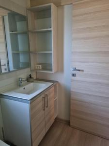 een badkamer met een wastafel en een spiegel bij Sweet house Pakoštane in Pakoštane +10 foto's