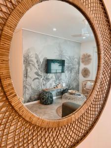 a mirror reflecting a living room with a tv at Coastal Bliss Lodge with Direct Beach Access in Ballito +39 photos