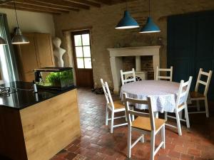 a kitchen and dining room with a table and a fish tank at Paulnay in Paulnay