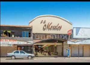 a car is parked in front of a building at Hospedaje Villa Hidalgo in Villa Hidalgo