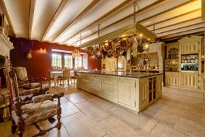 a large kitchen with a bar and a dining room at Chateau de la Triboulette in Vouzeron