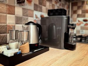 a coffee maker sitting on a counter next to a microwave at Mountain View Muscel Apartment in Câmpulung
