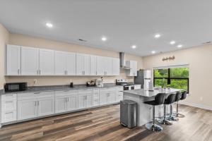 a kitchen with white cabinets and a counter top at Pet Friendly 3BR House in Charlotte in Charlotte
