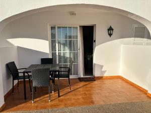 a dining room with a table and chairs at Apartamento 313 Castell Sol CB in Arenal d'en Castell