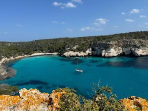 a small boat in a large body of water at Apartamento 313 Castell Sol CB in Arenal d'en Castell +2 photos