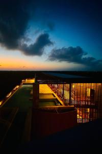 a view of a building at night with the sky at Jungle Guardian - Rooftop Pool & Beach Club in Zona Hotelera Tulum in Tulum +97 photos