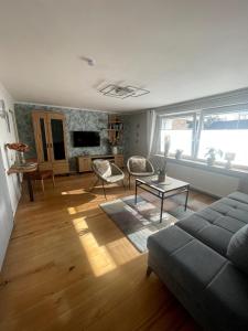 a living room with a couch and a table at Eifeltraum Mendig, 3 Sterne, Ferienwohnung in Mendig