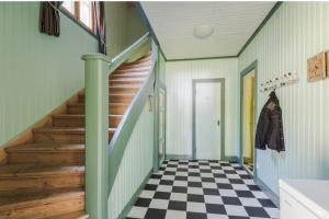 a hallway with a staircase and a checkered floor at Beautiful house in Fränsta in Fränsta