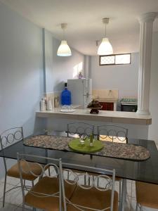 a kitchen with a dining table with chairs and a counter at Crucita Beach house in Crucita