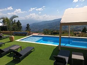 a swimming pool with a view of the mountains at HOSTERIA TERMAL VIVE PARADISE MEDELLIN Only Adult in Medellín +25 photos