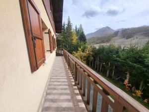 un balcón de una casa con vistas a la montaña en Chalet le Kern a Montgenevre pour 14 personnes, en Montgenèvre 4 fotos más