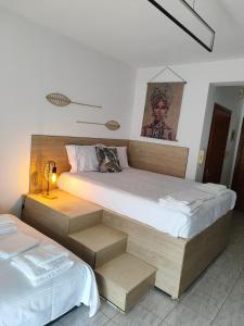 a bedroom with two beds and a lamp in it at Penthesileia Mare in Alexandroupoli +16 photos