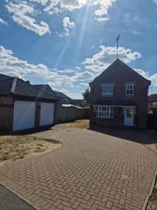 a brick driveway in front of a house at SK Short Let in Kilverstone