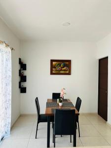 a dining room with a table and chairs at Casa Diamante Style, Peace & Prime Location in Manzanillo