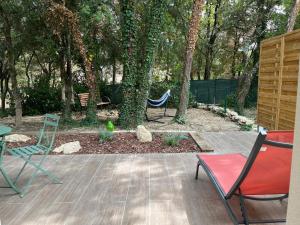 グリニャンにあるGîte Chez Erika et Mathiasの庭園内のパティオ(椅子、ハンモック付)