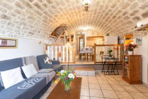 a living room with a couch and a table at Le Mas De La Blache in Payzac +15 photos
