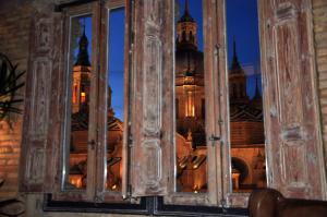a view of a cathedral through a window at Apartamentos Basilicus in Zaragoza