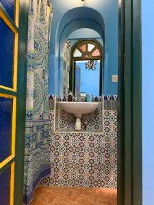 a bathroom with a sink and a mirror at Casa del Sol Marrakech in Marrakech +37 photos