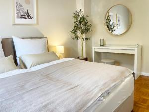 a bedroom with a white bed and a mirror at Rooms 34 in Schweinfurt