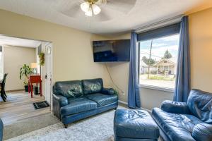 a living room with two leather couches and a window at 17 Mi to Bear Lake Lovely Family Home! in Montpelier