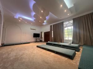 a large room with couches and a tv in it at Project ADAM in Ras al Khaimah