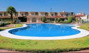 a large swimming pool in front of a building at AIFA Airport security-privacy-comfort in Tizayuca