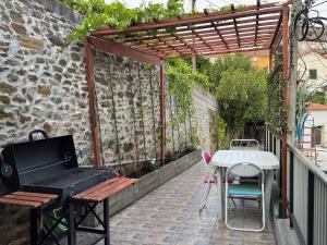a patio with a table and a bench and a table at Sobreira Stone Cottage in Peso da Régua