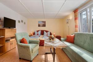 a living room with a couch and a table at Ferienbungalows Werner in Ostseebad Koserow