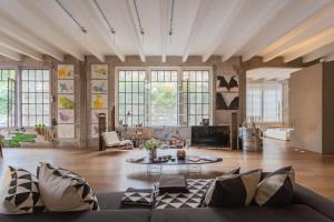 a living room with a couch and a table at Design Loft with Private Parking by Rent All Como in Como