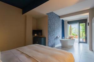 Vista Lario by Rent All Como في Carate Urio: غرفة نوم بسرير وحوض ونافذة